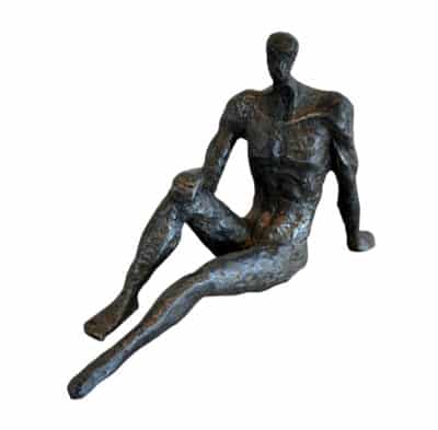 Bronze sculpture of a seated figure with one arm raised.