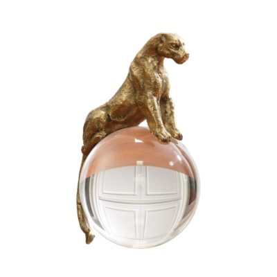 Brass figurine of a lion sitting on a crystal ball