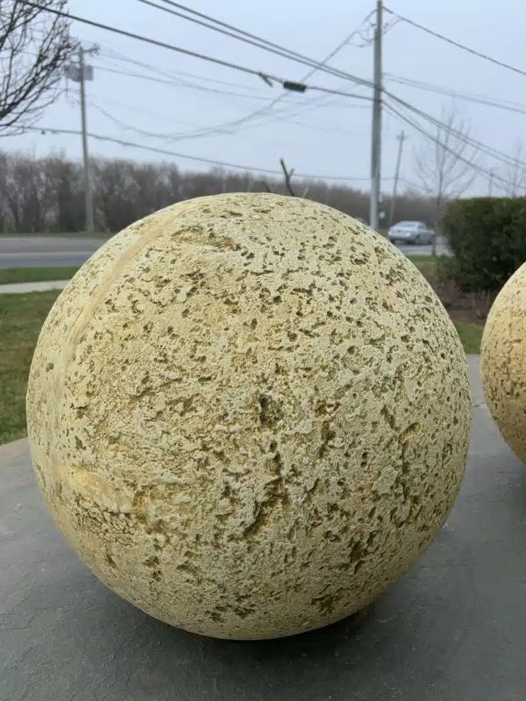 Close-up of Large Distressed Oversized Concrete Ball in Lightly Beige Gray, 30"D x 31"H, 65 Pounds GO-1420-LGSPHERE.