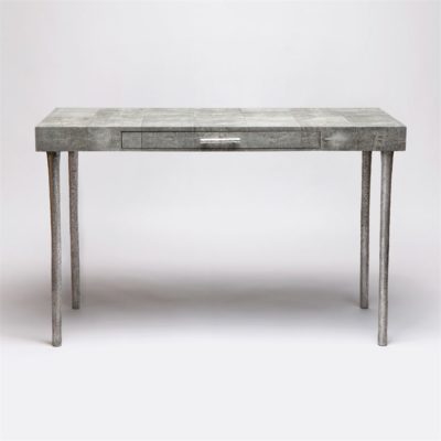 The image presents a modern sleek desk with a faux shagreen finish and silver metal legs Its design is accentuated by a