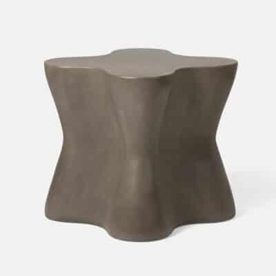 Large outdoor concrete side table in raw finish with dark grey color and natural distressing.
