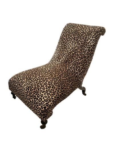 Close-up of antique perching chair in leopard print, reupholstered, Queen Anne style.