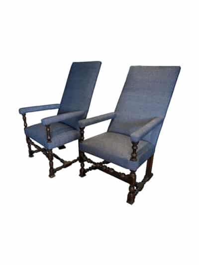 Close-up of antique chairs with intricate carvings and blue upholstery, showcasing French craftsmanship from circa 1700.