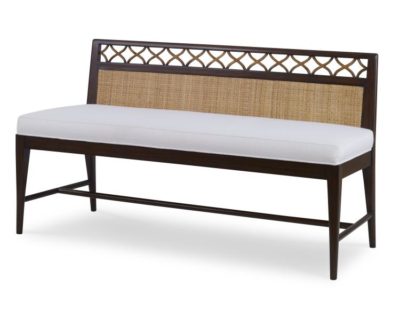 A bench with a rattan frame and cane accents featuring a woven design on top The bench has a white cushion seat