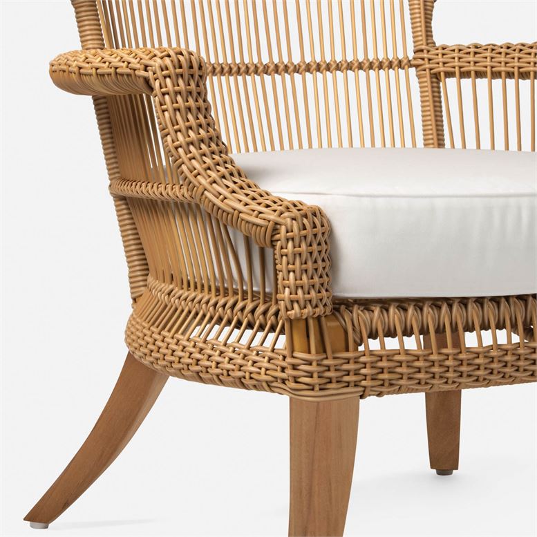 The image showcases an Elizabethan Outdoor Chair exhibiting its brown rattan texture and teak legs The chair is presented in profile view