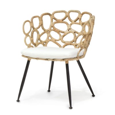 A modern, retro blonde rattan chair with a white cushion on top, placed on a black metal frame.