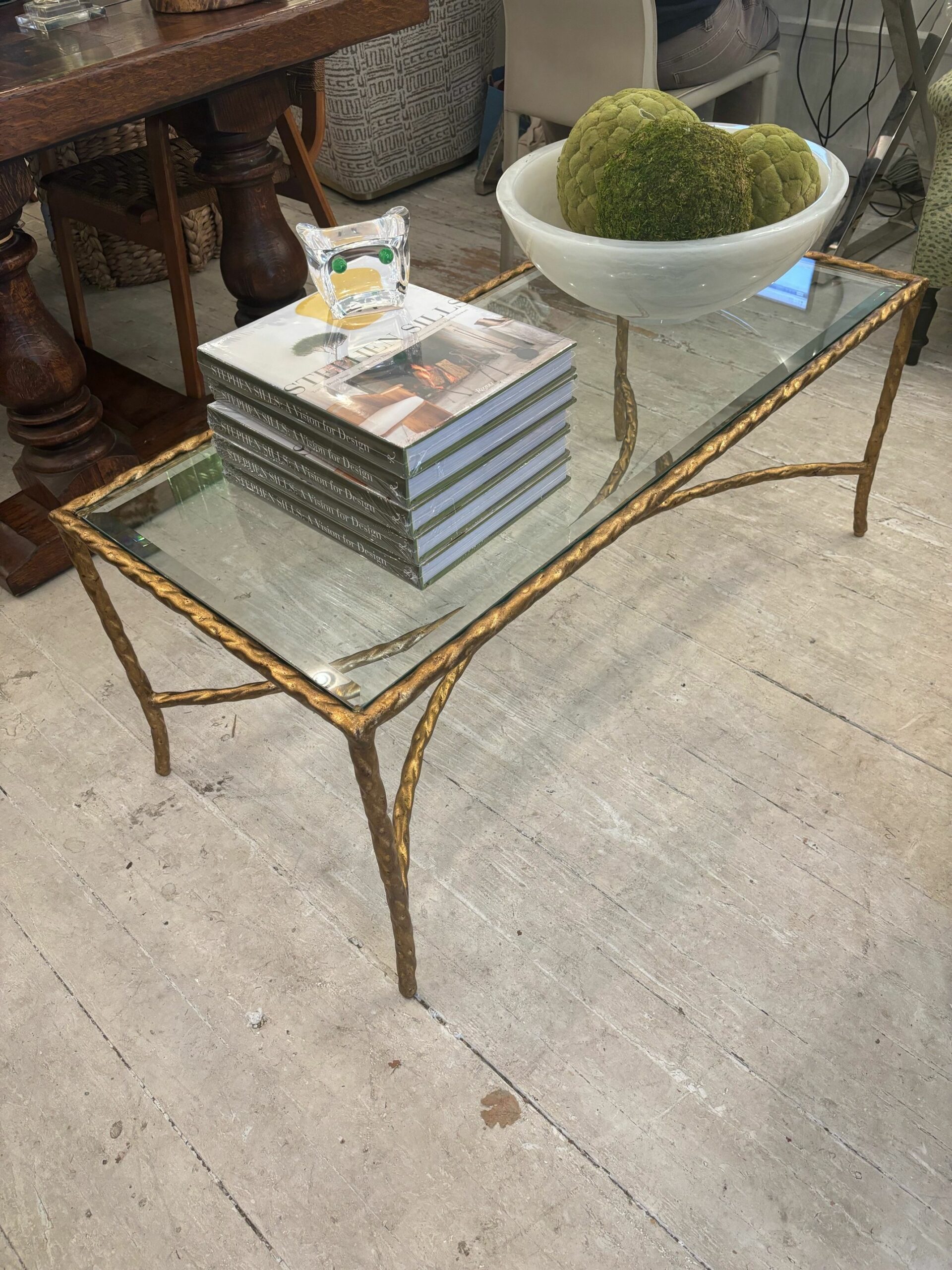 Gilded metal twist coffee table with rectangular glass top.