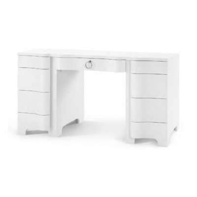 A white lacquered grasscloth desk with chrome pulls.