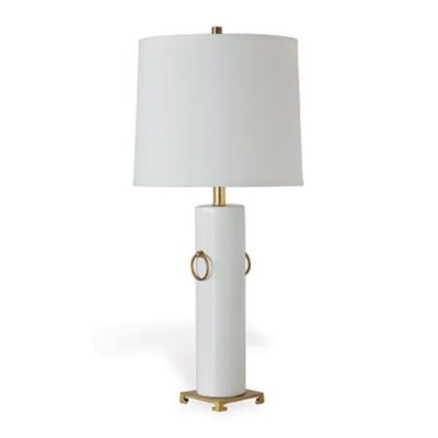 A tall elegant table lamp with a white shade and brass rings exuding a sense of modern sophistication The base is off-white