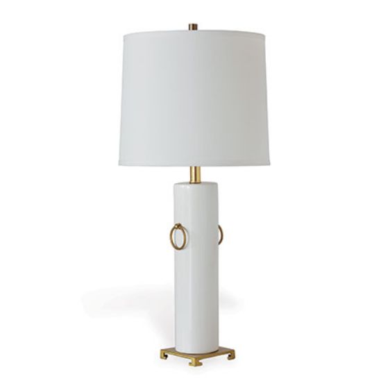 A tall elegant table lamp with a white shade and brass rings exuding a sense of modern sophistication The base is off-white
