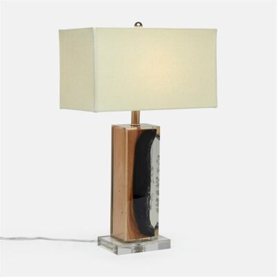 Sleek modern table lamp featuring a burnt raw wood base encased in resin, with a natural linen shade on a lucite base.