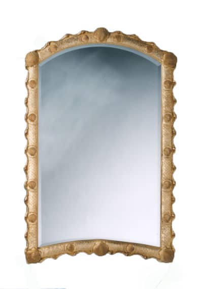 Gilded mirror with ornate frame and reflective surface.