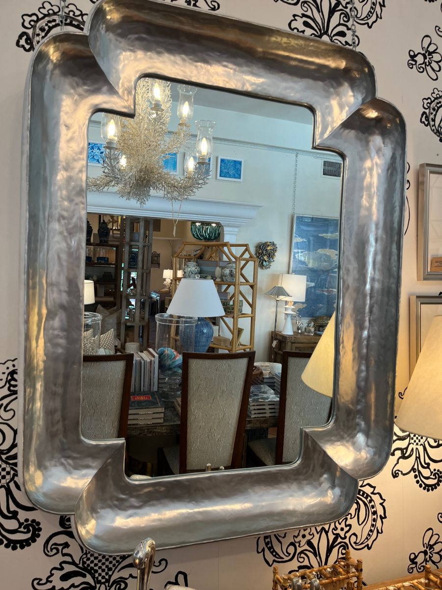 Reflective corner mirror in modern design with elegant frame options available.