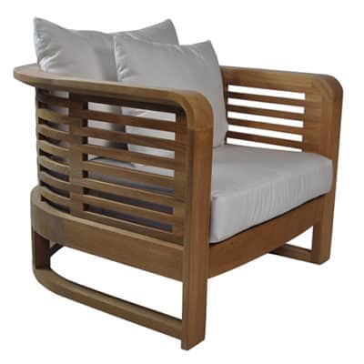 Outdoor curved back teak arm chair with white cushion and natural outdoor fabric upholstery.