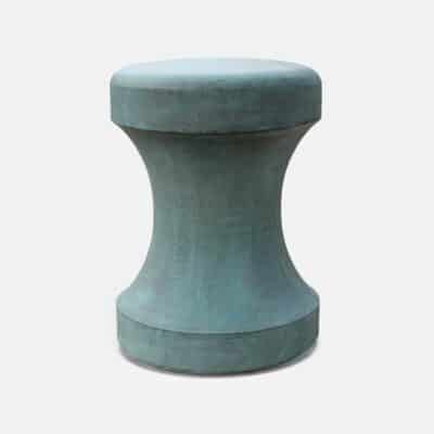 An outdoor concrete chess piece stool with a hollow reconstituted stone structure and an aged patina finish in light gray.