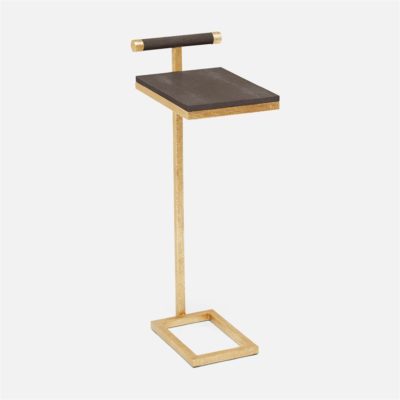 A small, modern side table with a black faux shagreen top and gold base.