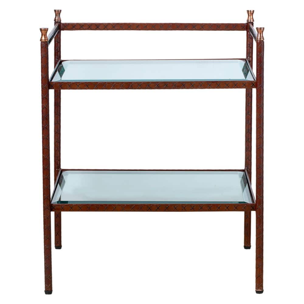 A wooden side table with a glass shelf and brass finials wrapped in leather with a pattern that varies from light to