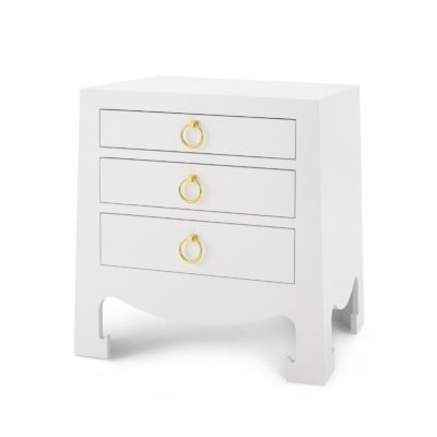 Small white lacquered side table with three drawers and a visible antiqued gold pull, showcasing its stained interior.
