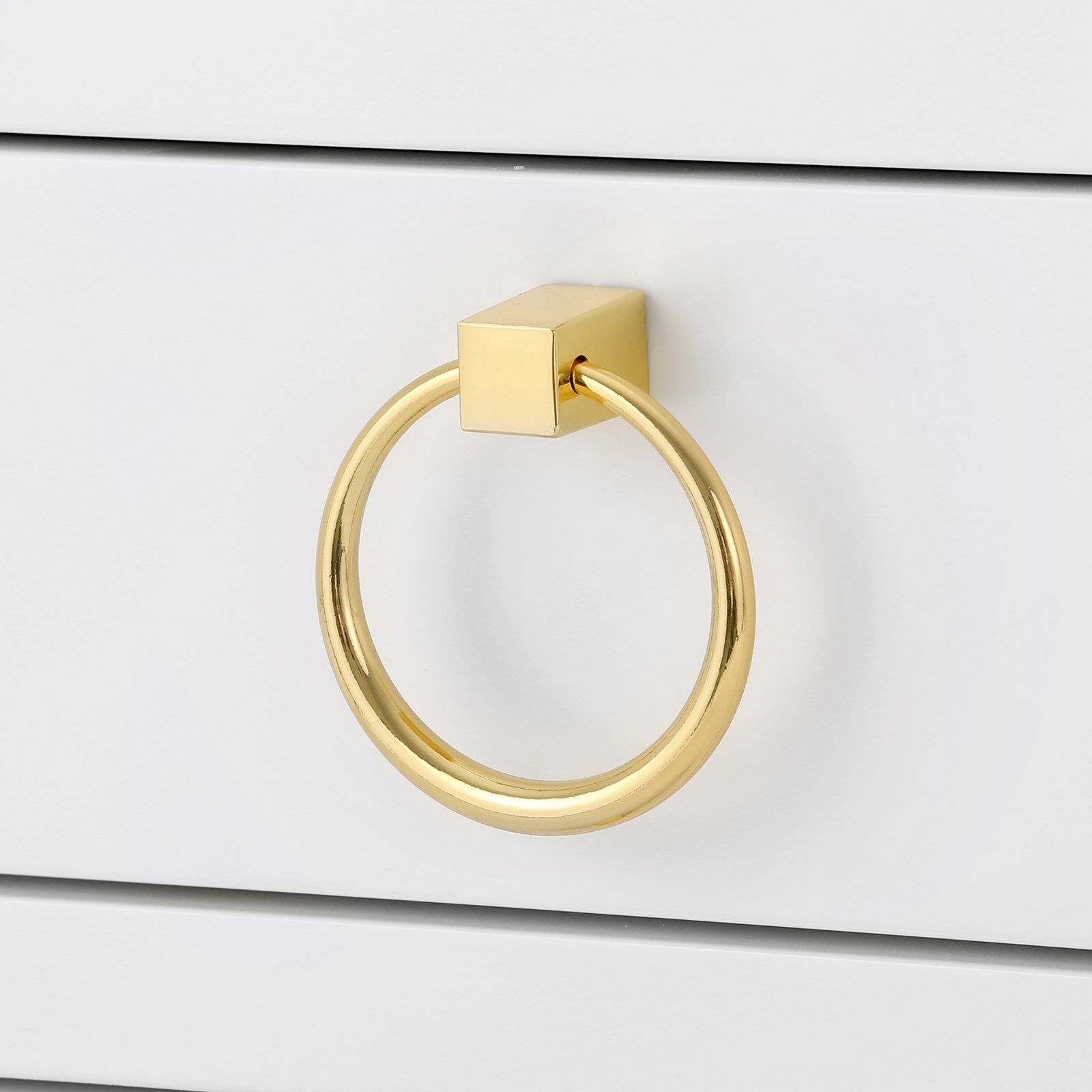 Antique gold ring mounted on a white lacquered side table.