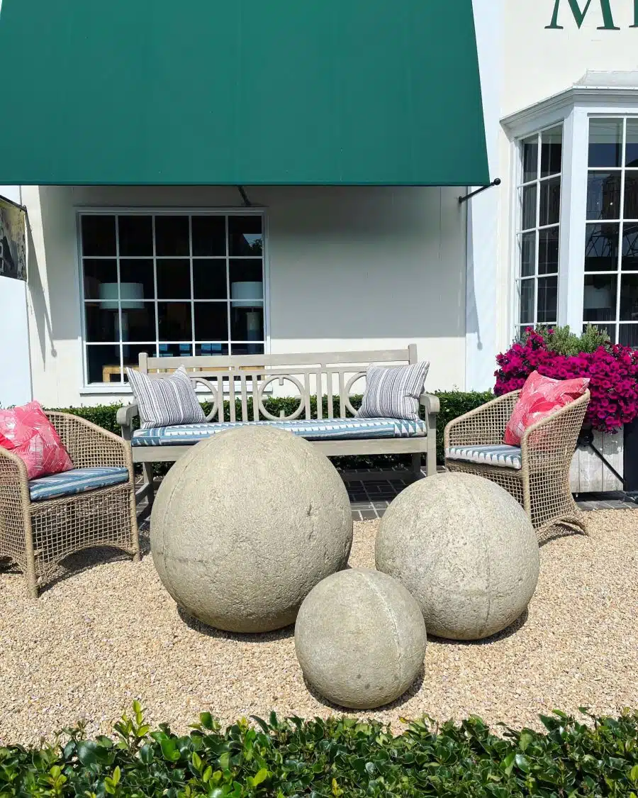 Oversized concrete balls in rough dark gray finish, perfect for garden ornaments.