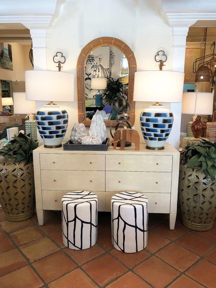 A large, white double dresser with six drawers in a room.