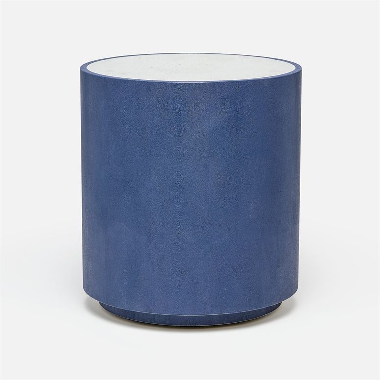 A round, dark blue faux shagreen side table with a mirrored top, set against a light background.