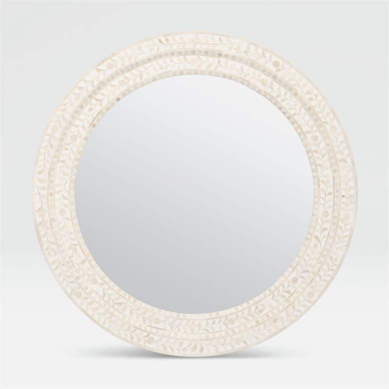 Large round mirror with a tan and white bone frame.
