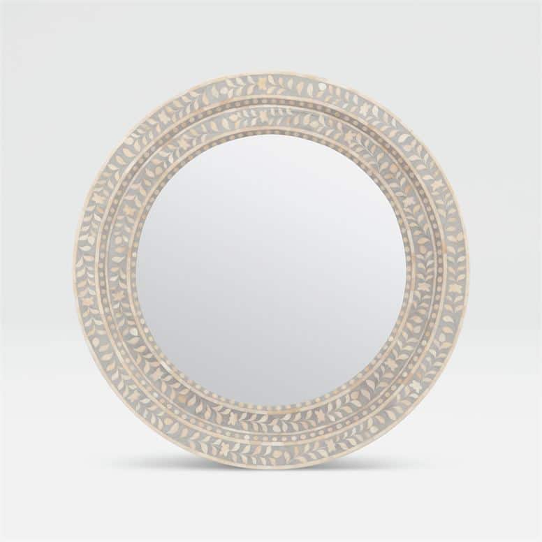 Large tanen mirror with a white resin frame and intricate bone inlay design featuring a circular shape and set against a neutral