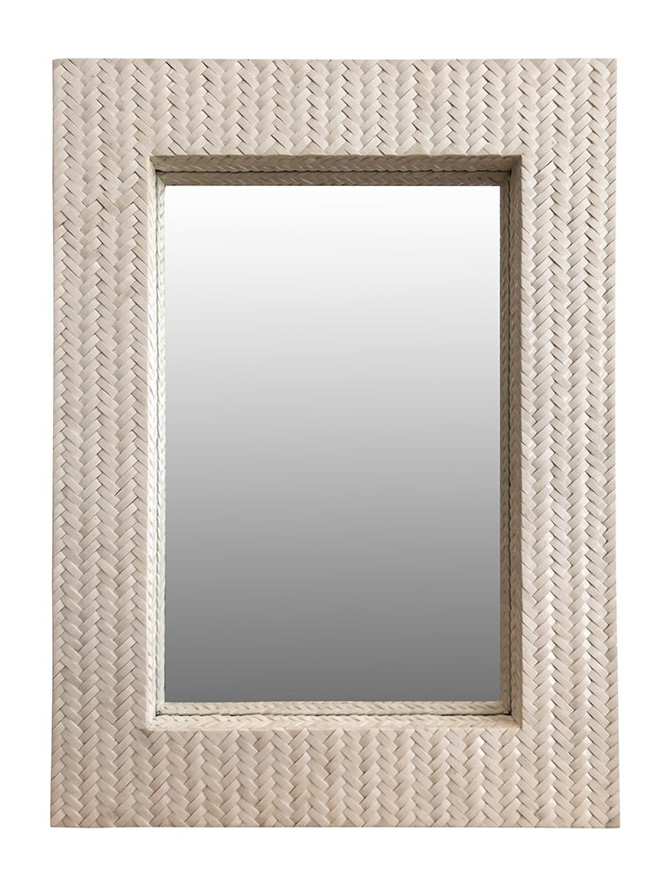 Woven wicker frame around a rectangular mirror with a silver backing, set into a wall.