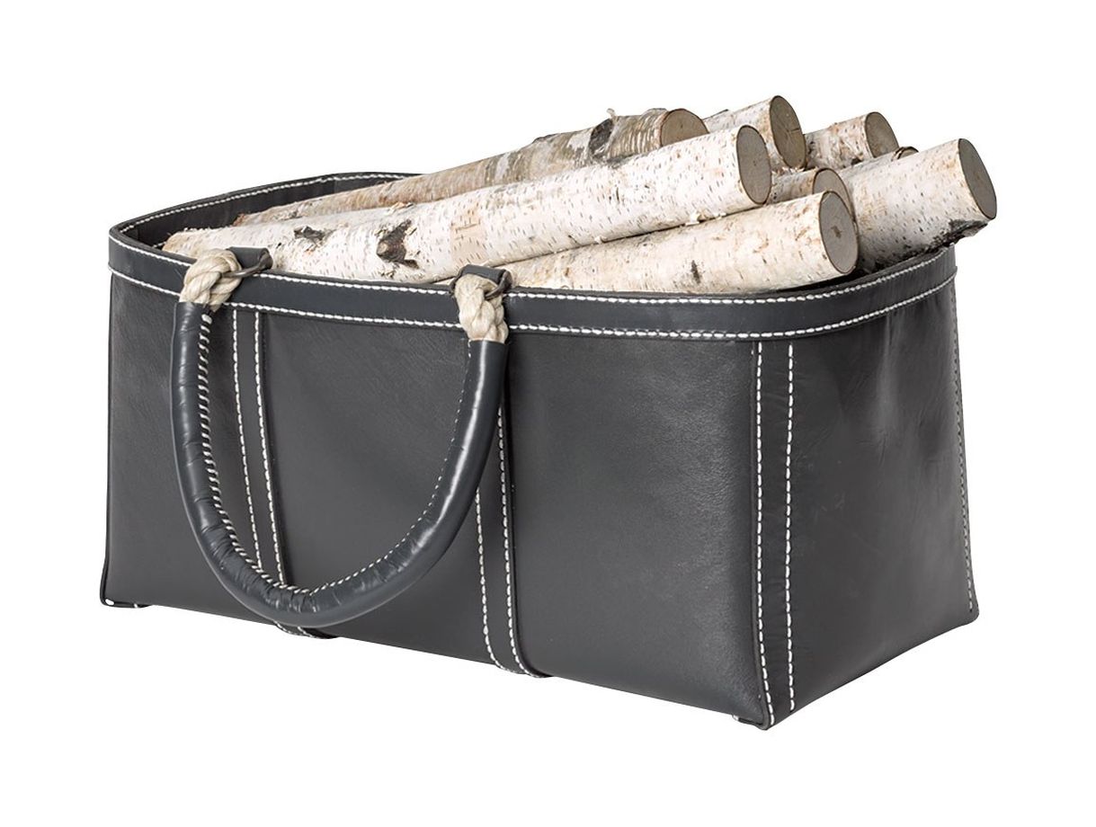 Black leather bag with handles, filled with firewood and topped with a rope handle.