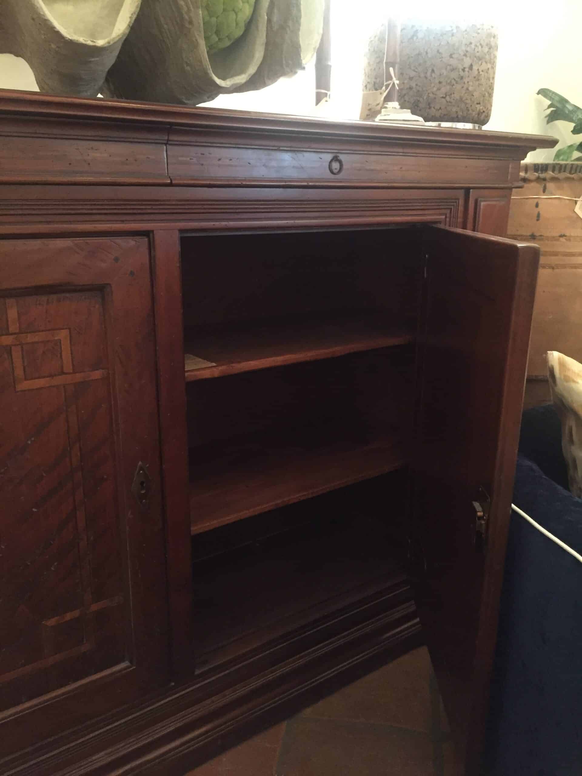 Wooden buffet with two removable interior shelves per door, two slim upper drawers with small ring pulls.