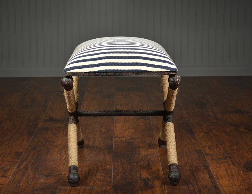 Small navy and white striped ottoman with rustic iron frame