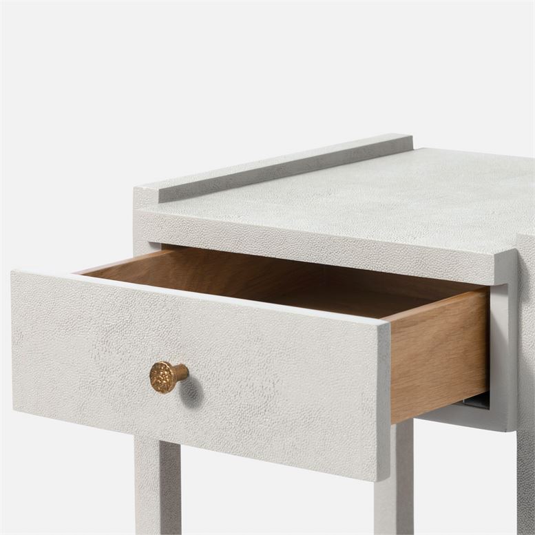 A modern minimalist nightstand with a rectangular top and a single drawer featuring a sleek design with a metallic handle and a