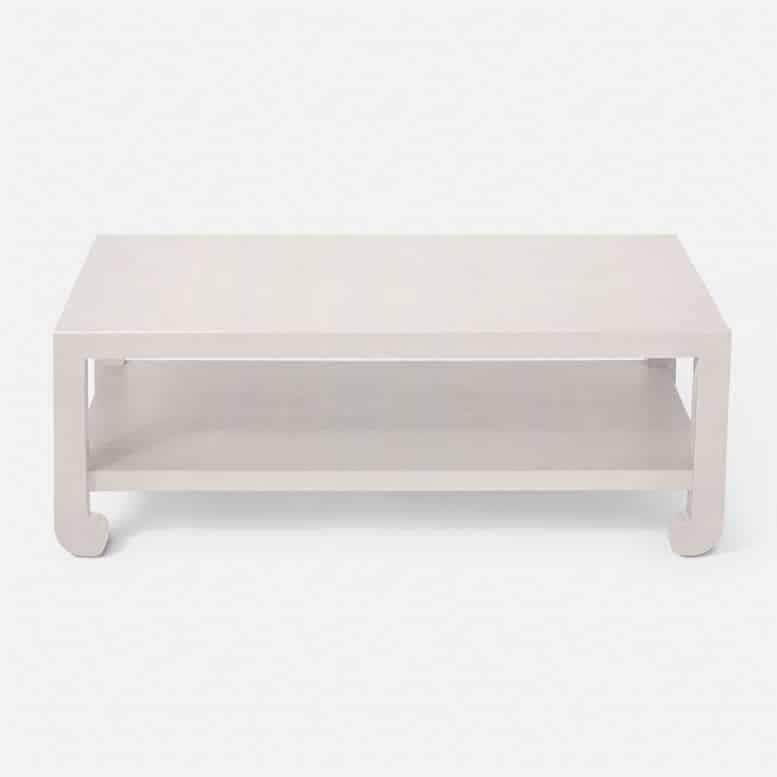 White coffee table with a modern design, featuring a rectangular top and a low profile.
