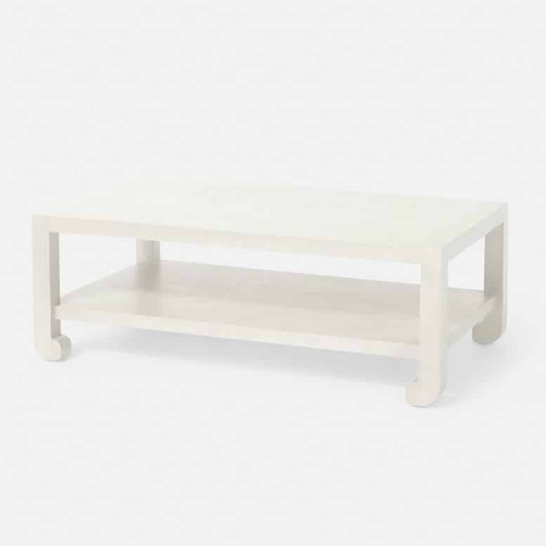 White coffee table with a rectangular top and four legs, set against a plain background.
