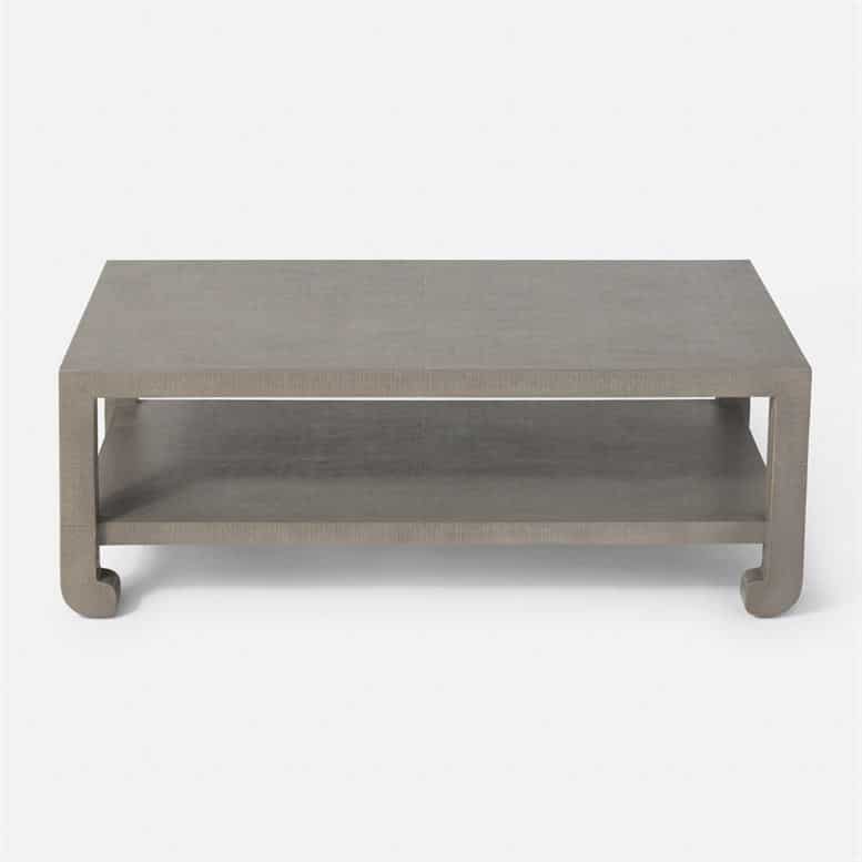 A rectangular coffee table with a modern design featuring a faux raffia finish and a geometric pattern on the top surface It