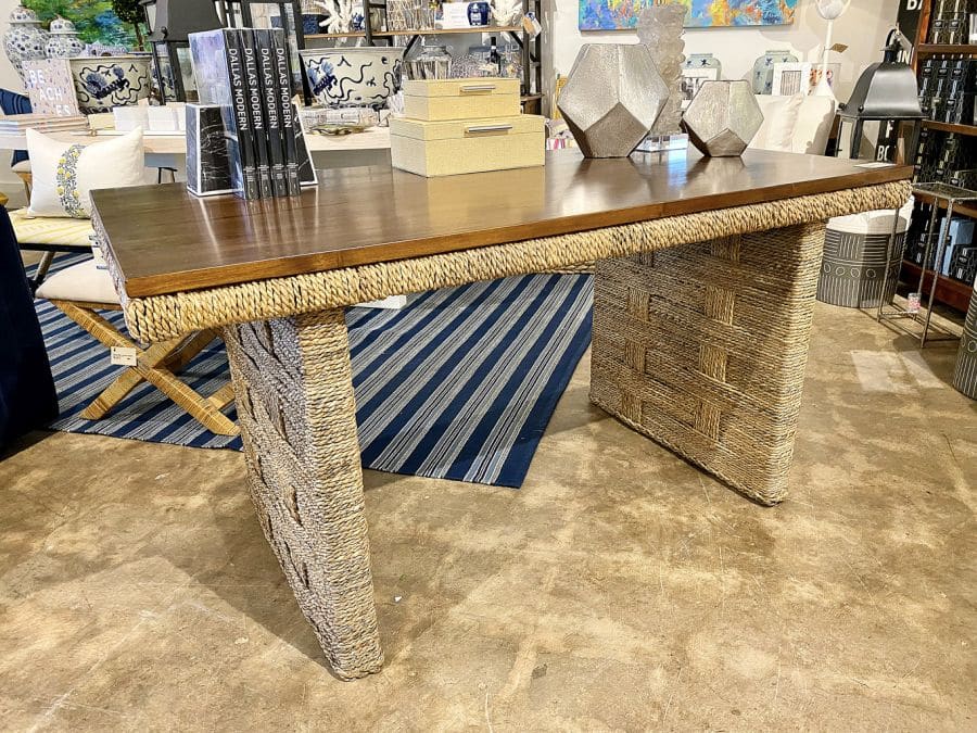 Close-up of an attractive Colby Teak and Woven Desk, showcasing its French inspired interwoven rope base and teak top.