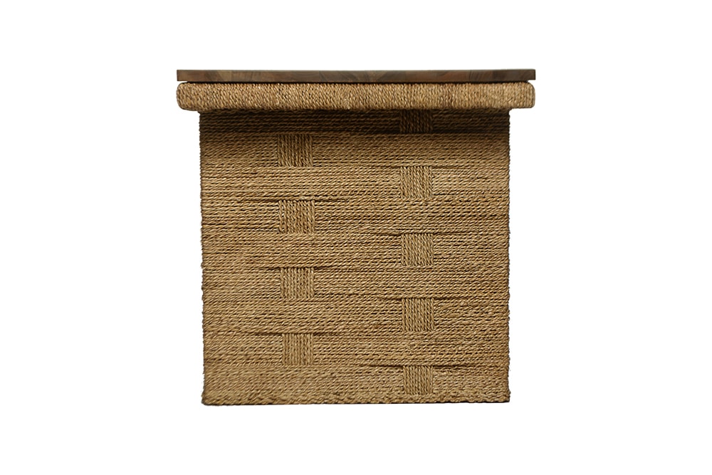 A woven basket with a teak top, sitting on a surface.