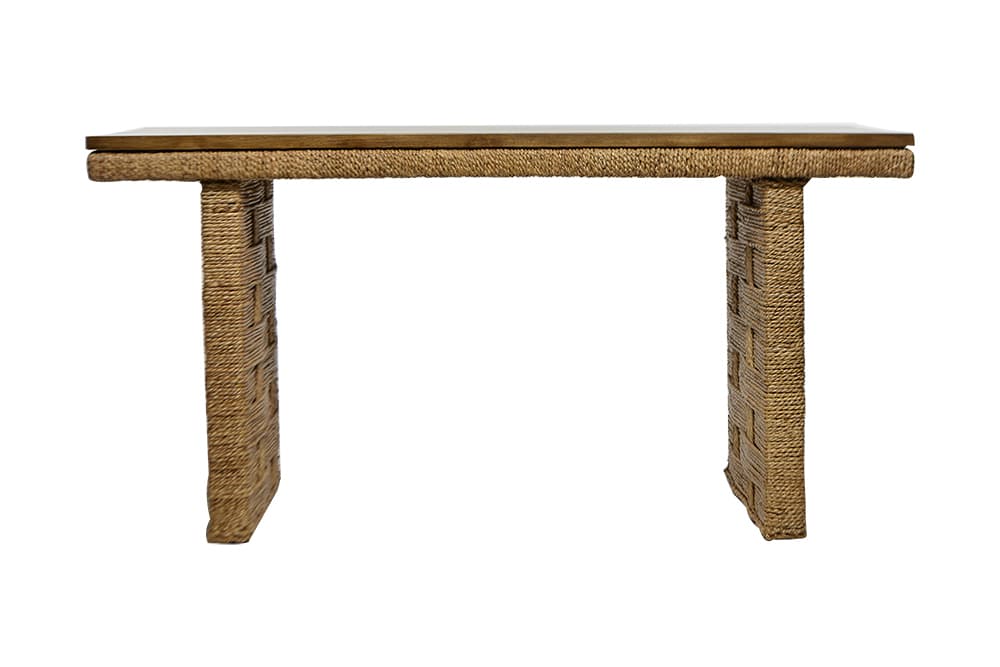 A wooden desk with a woven base and teak top, presented in an East Warehouse setting.