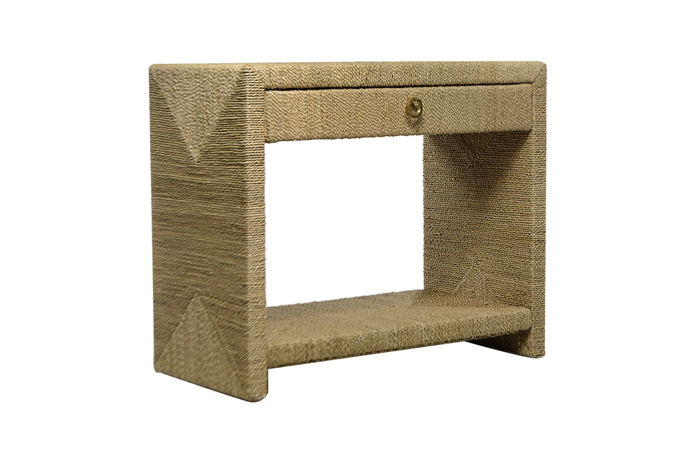 A tall rectangular side table with a rope texture design on its surface and a drawer at the bottom The table is