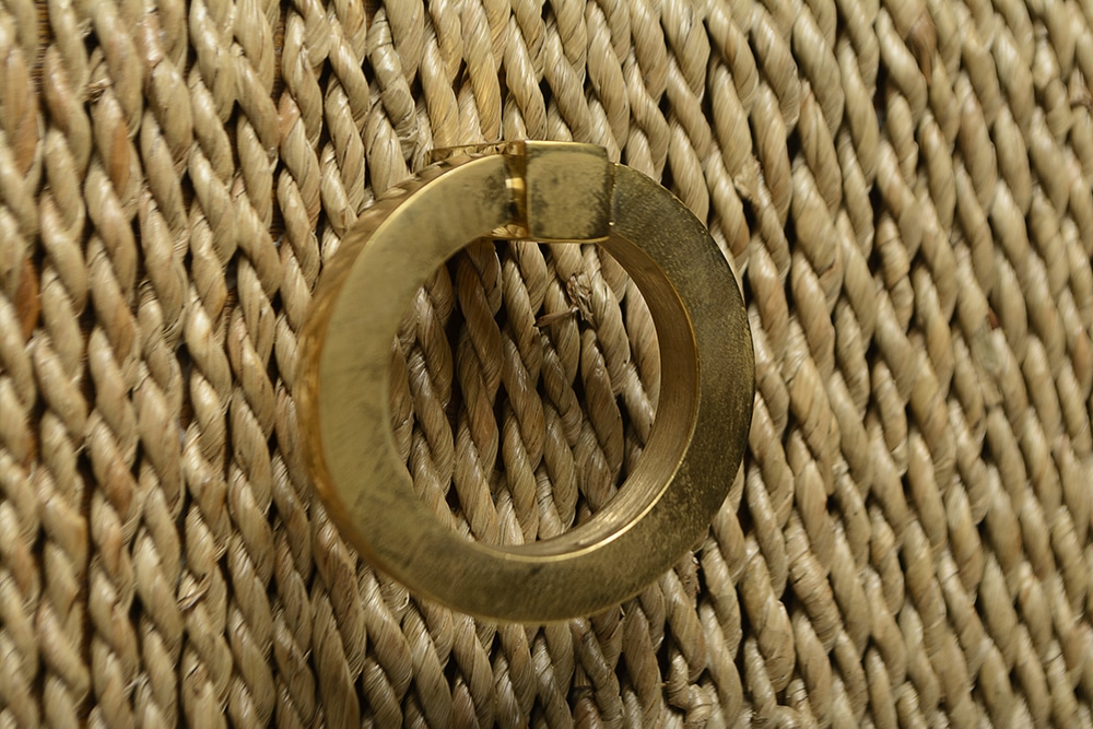 Gold ring on a woven fabric surface
