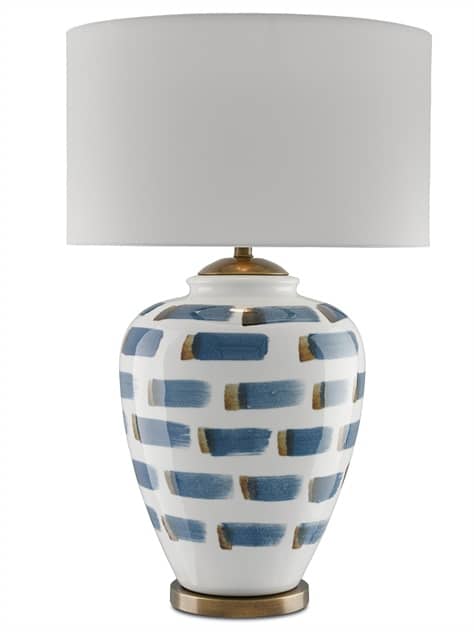 A blue and brown flat brushstroke table lamp with a white linen shade and antiqued brass hardware.