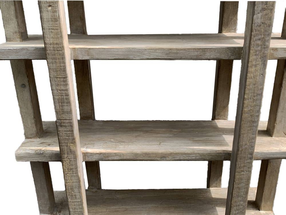 A wooden bookcase made from reclaimed pine with a light white wash finish, displayed in a store.