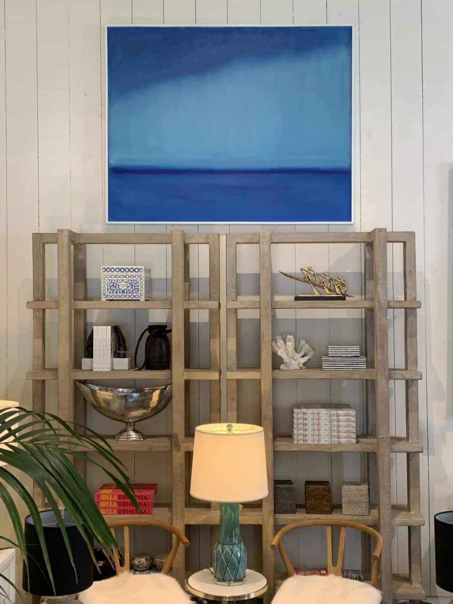 A reclaimed wood bookcase with a light wash finish, displayed in a store.