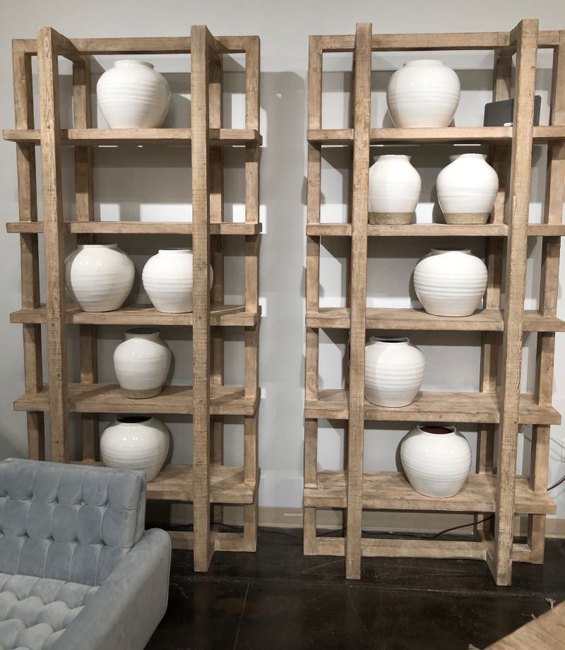 Wooden bookcase with multiple shelves, each holding a vase.