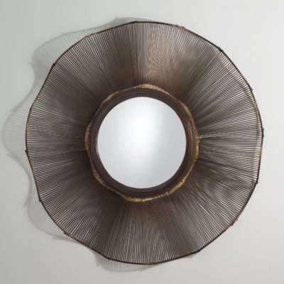 Small round mirror with a wavy frame made of bronze metal, featuring brass edges and highlights.