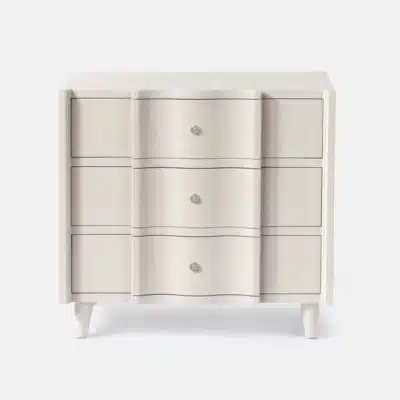White nightstand with three drawers, featuring a faux raffia finish and knobs, against a white background.