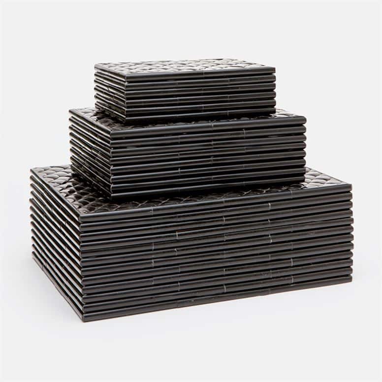 Black and white faux fish scale boxes stacked in a pile with natural bone or black horn finish available in three sizes