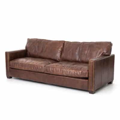 Brown leather sofa with antiqued brass nail head trim