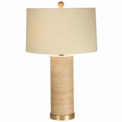 A lamp with a brass base and a drum shade wrapped in burlap, standing upright against a white background.